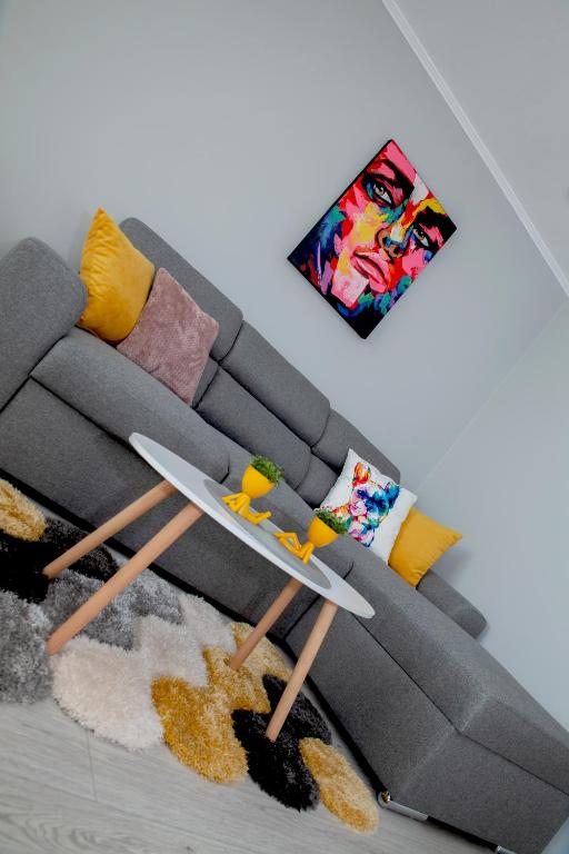 a living room with a couch with a table at Stadium Apartments in Veliko Tŭrnovo