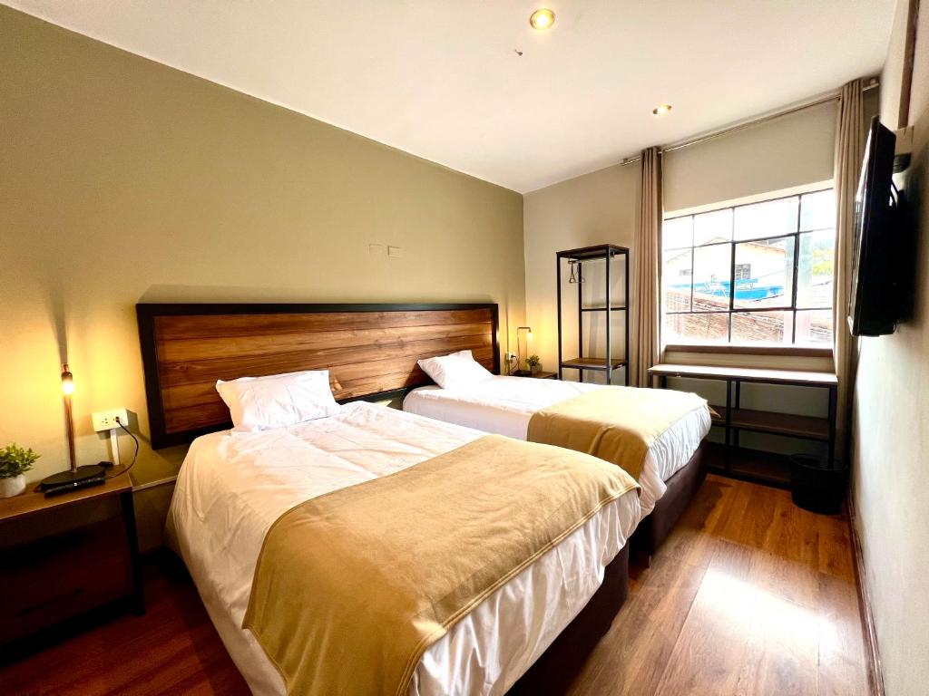 Postel nebo postele na pokoji v ubytování Hostal María Angola