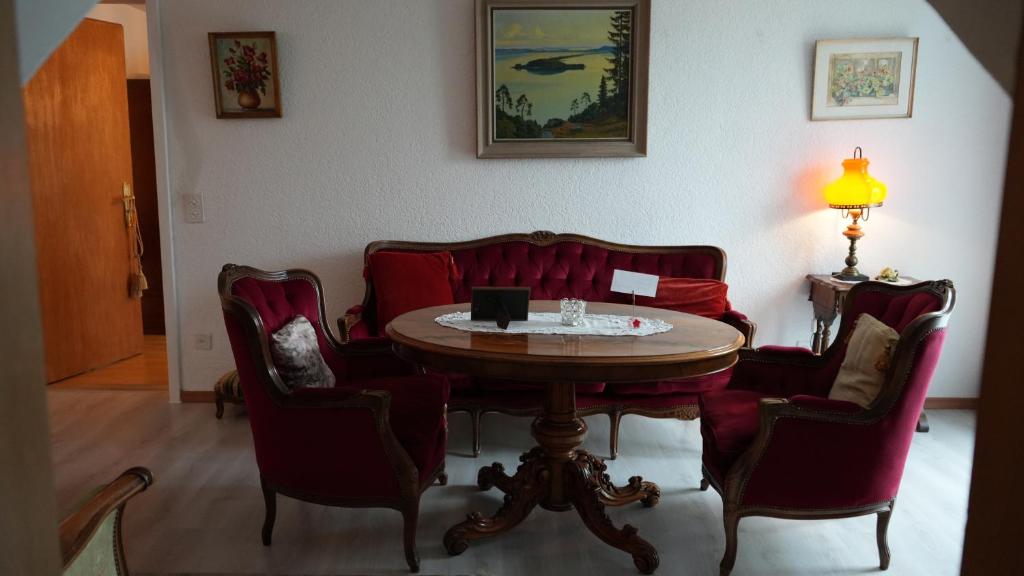 a room with a table and chairs and a couch at Dream apartment in nice villa near forest in Brügg