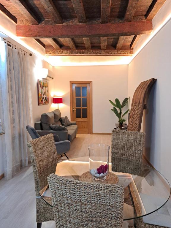 a living room with a glass table and chairs at Casa Buzones in Toledo