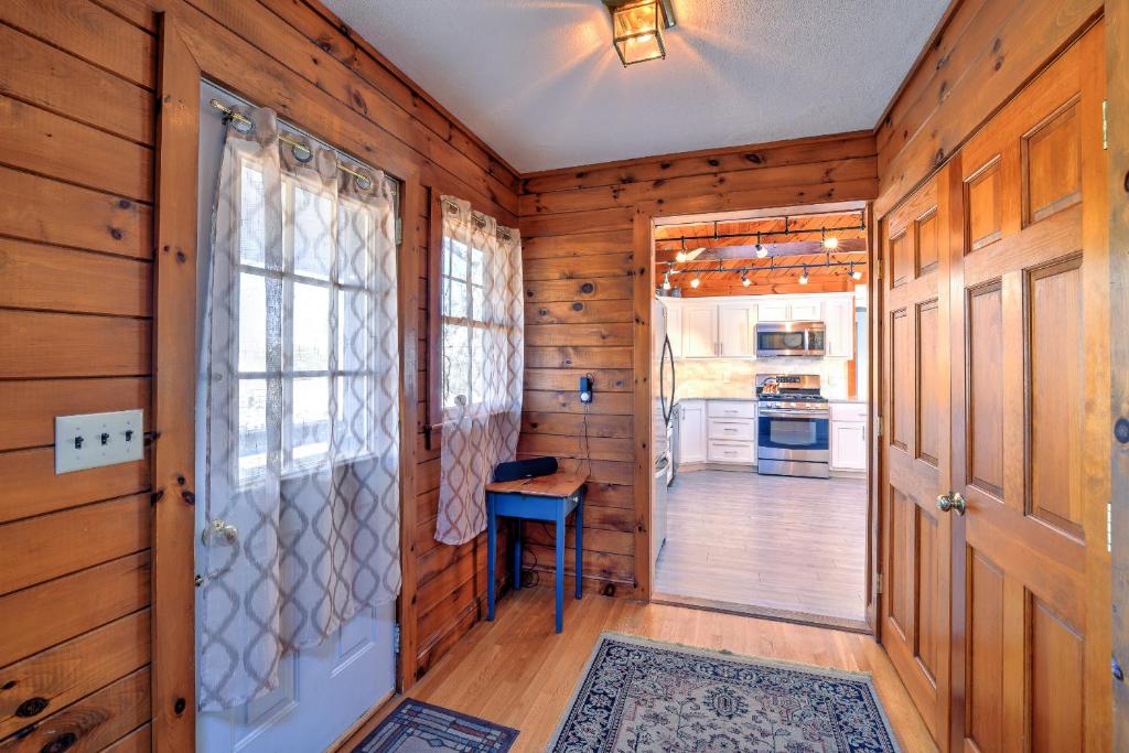 a wooden hallway with a door and a table in a kitchen at 10 Chadwell Avenue Sandwich - Cape Cod in Sandwich