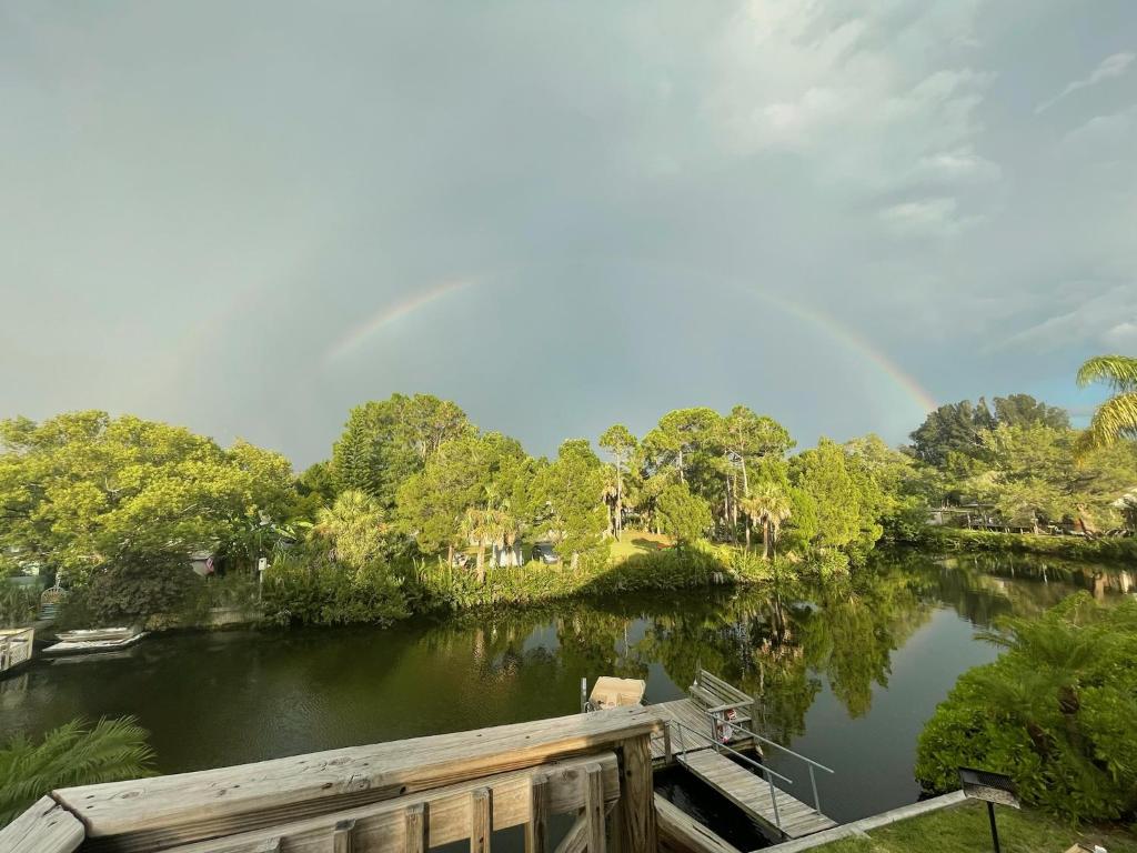 a bridge over a river with a rainbow in the sky at 4BR Private Dock, Warm Spring Canal, Kayaks, Canoe in Hudson
