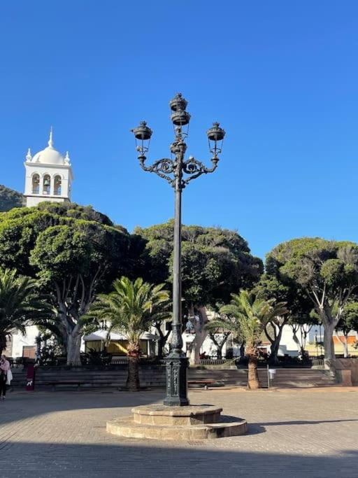 światło uliczne w parku z wieżą zegarową w tle w obiekcie Bonita casa en el corazón del pueblo! Villa Carmen w mieście Garachico