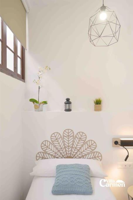 Łóżko lub łóżka w pokoju w obiekcie Bonita casa en el corazón del pueblo! Villa Carmen