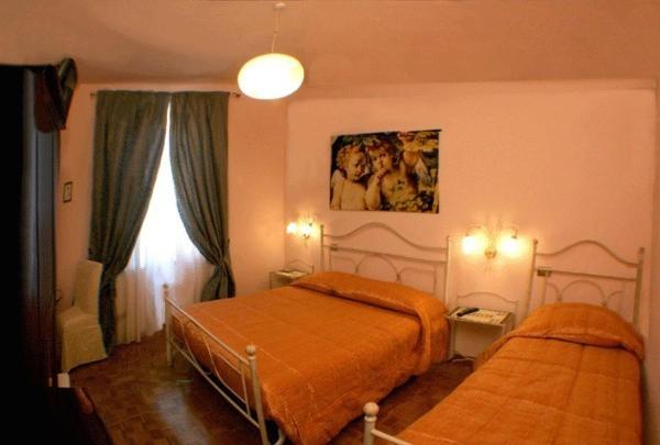 sypialnia z 2 łóżkami i oknem w obiekcie B&B Le Campane w mieście Ferrara