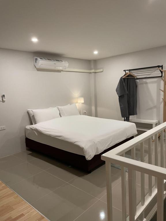 a bedroom with a bed and a staircase with at Sealoft,Pattaya in Bang Lamung