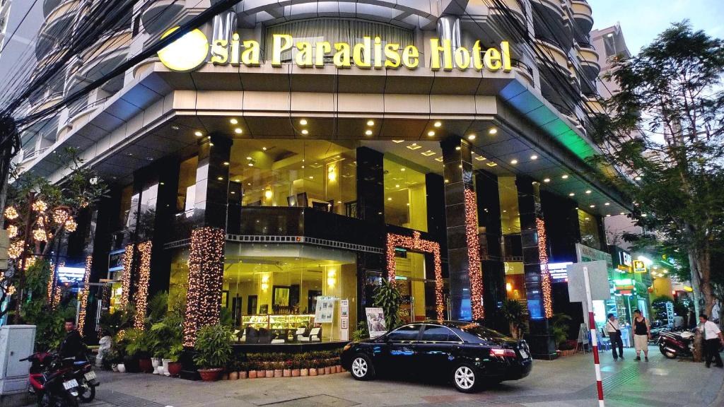a black car parked in front of a store at Asia Paradise Hotel in Nha Trang