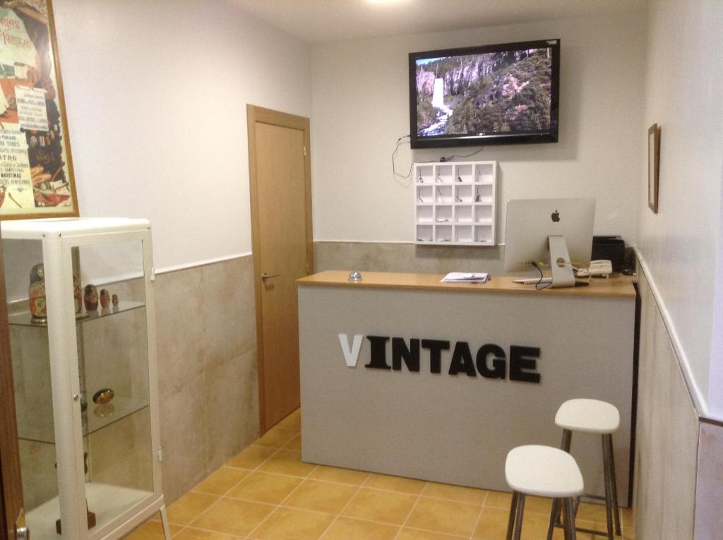 a kitchen with a television and a refrigerator at Hostal Vintage Santander in Santander
