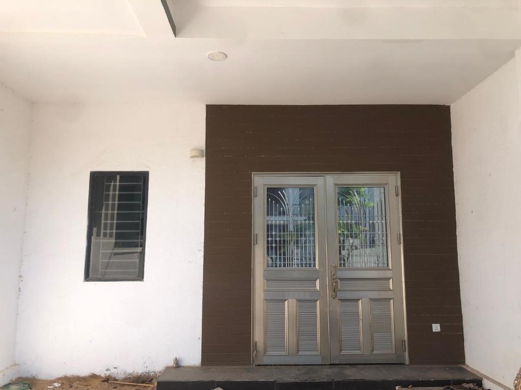 a front door of a house with brown and white at Your living & working sanctuary near Phnom Penh in Phumĭ Kândal (2)