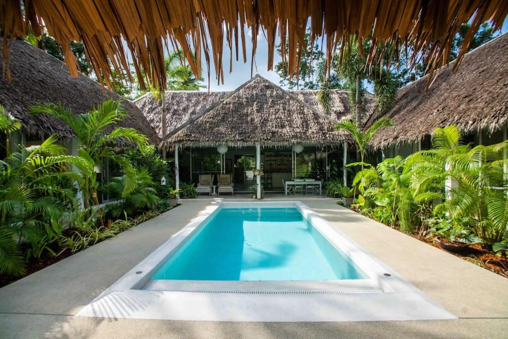 an outdoor swimming pool in front of a house at Koh Phangan luxurious pool and garden villa in Haad Rin