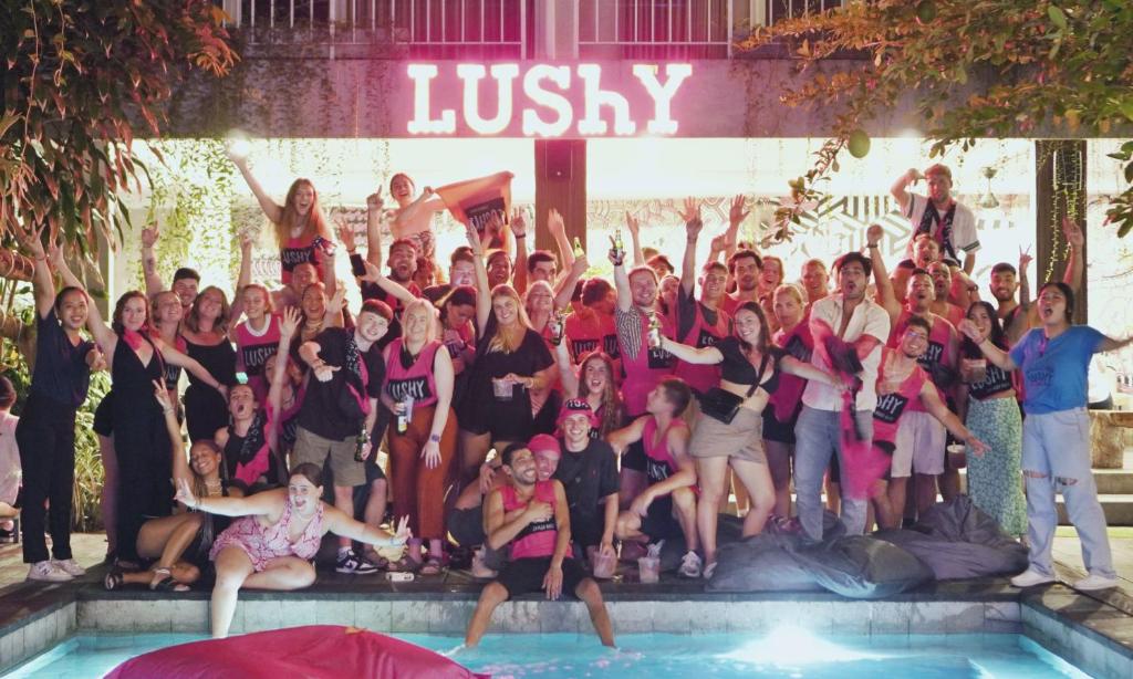a group of people posing in front of a swimming pool at Lushy Hostel Canggu in Canggu