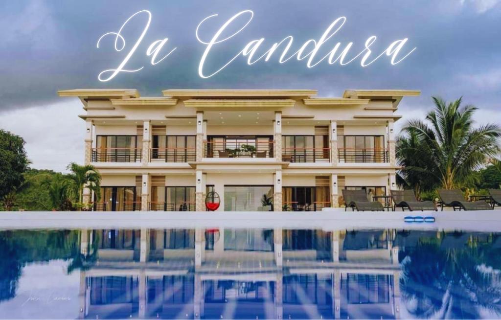 a hotel with a pool in front of it with the words la jamaica at La Candura in Siquijor