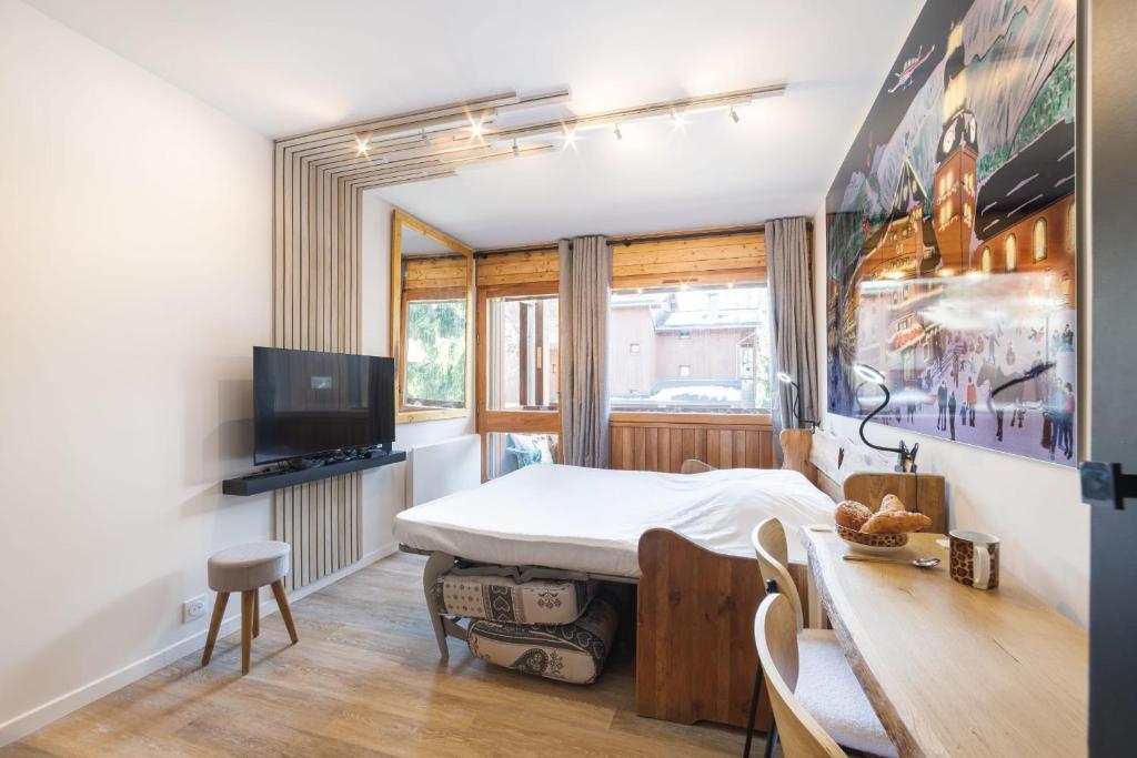 Televízia a/alebo spoločenská miestnosť v ubytovaní Studio l'Orée - City centre - Megève
