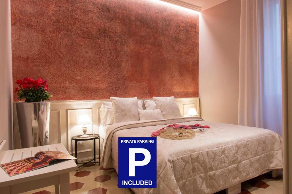 a hotel room with a bed with a sign on it at B&B PISTOIA INN in Pistoia