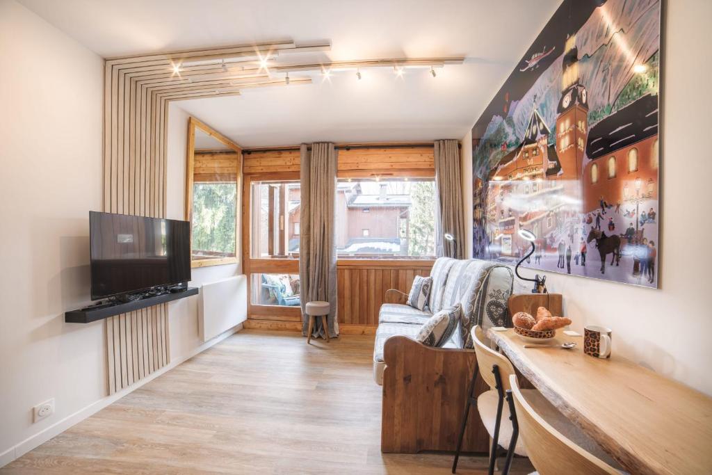 Televízia a/alebo spoločenská miestnosť v ubytovaní Studio l'Orée - City centre - Megève