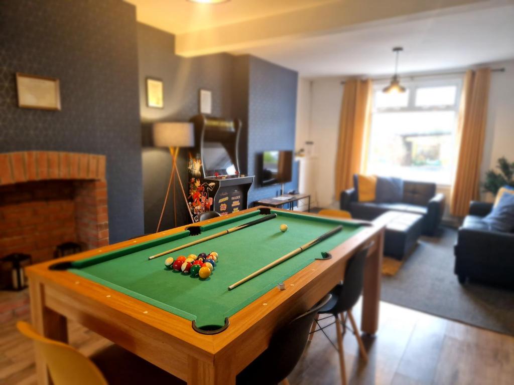 a living room with a pool table in a living room at Family friendly, Modern House just 1m from Bike Park Wales in Merthyr Tydfil