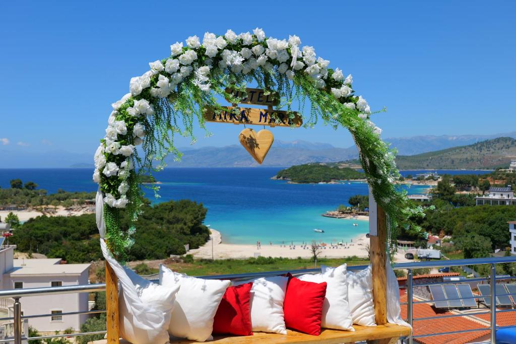 a wedding arch with a bench on a balcony at Hotel Ajden by Mira Mare in Ksamil