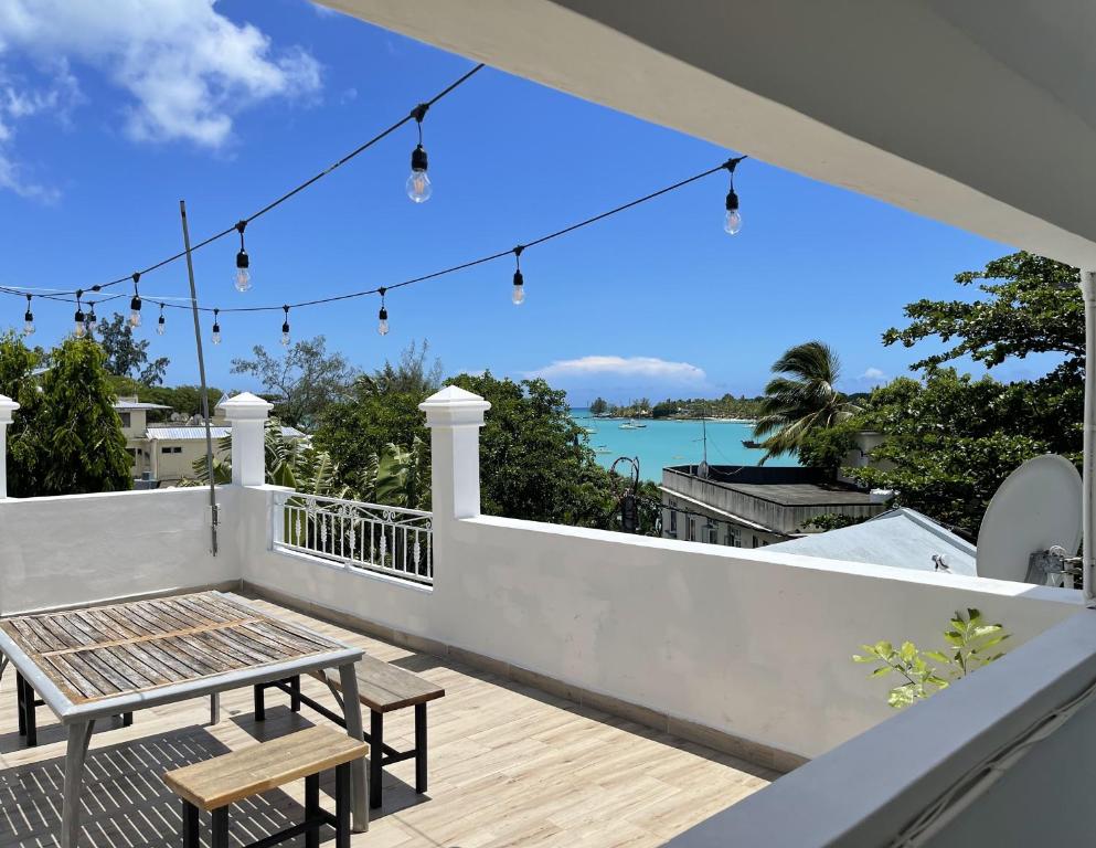 a patio with a table and chairs on a balcony at Studio H GrandBay Sea-View in Grand-Baie