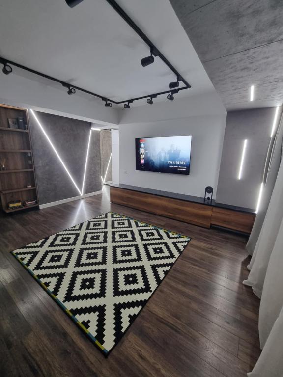 Cette chambre dispose d'une télévision et d'un tapis. dans l'établissement Eclipsei ApartHotel, à Popeşti-Leordeni