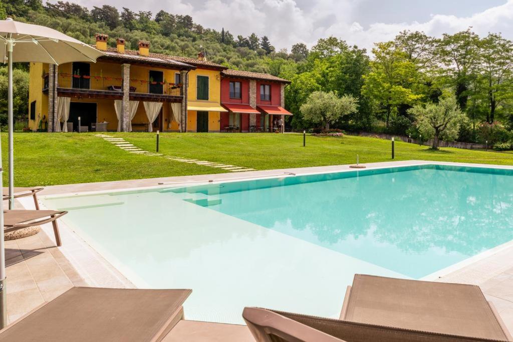 a large swimming pool in front of a house at Rovertondo in Costermano