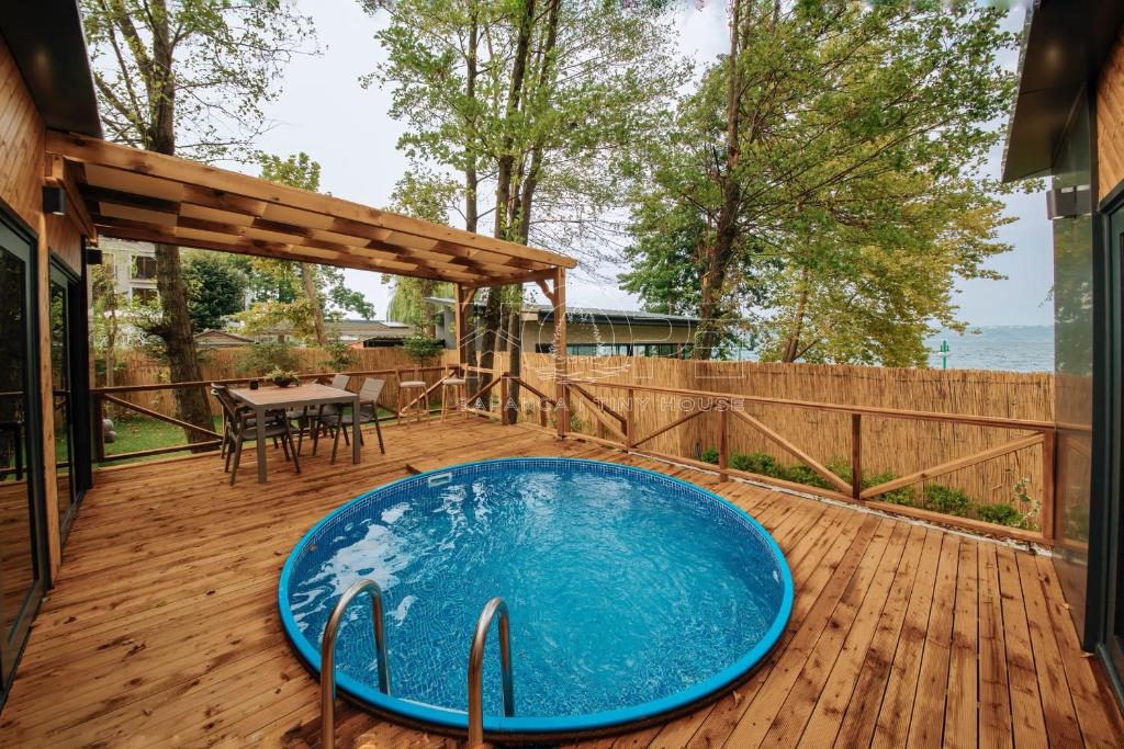 a blue pool on a wooden deck with a table at HOPE SAPANCA in Sakarya