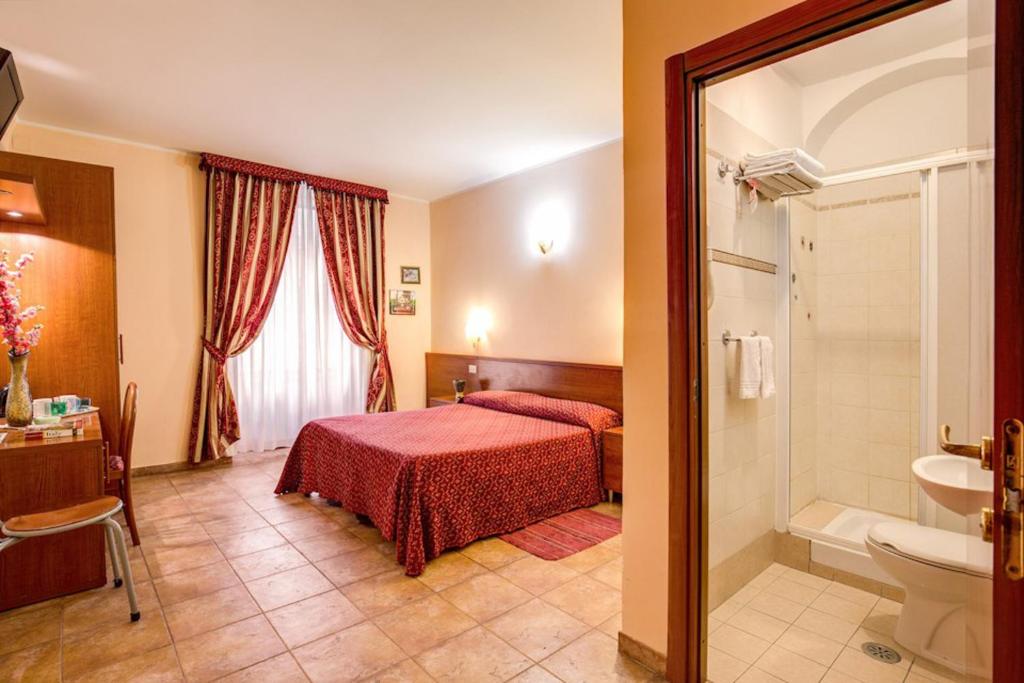 a hotel room with a bed and a bathroom at Giovy in Rome