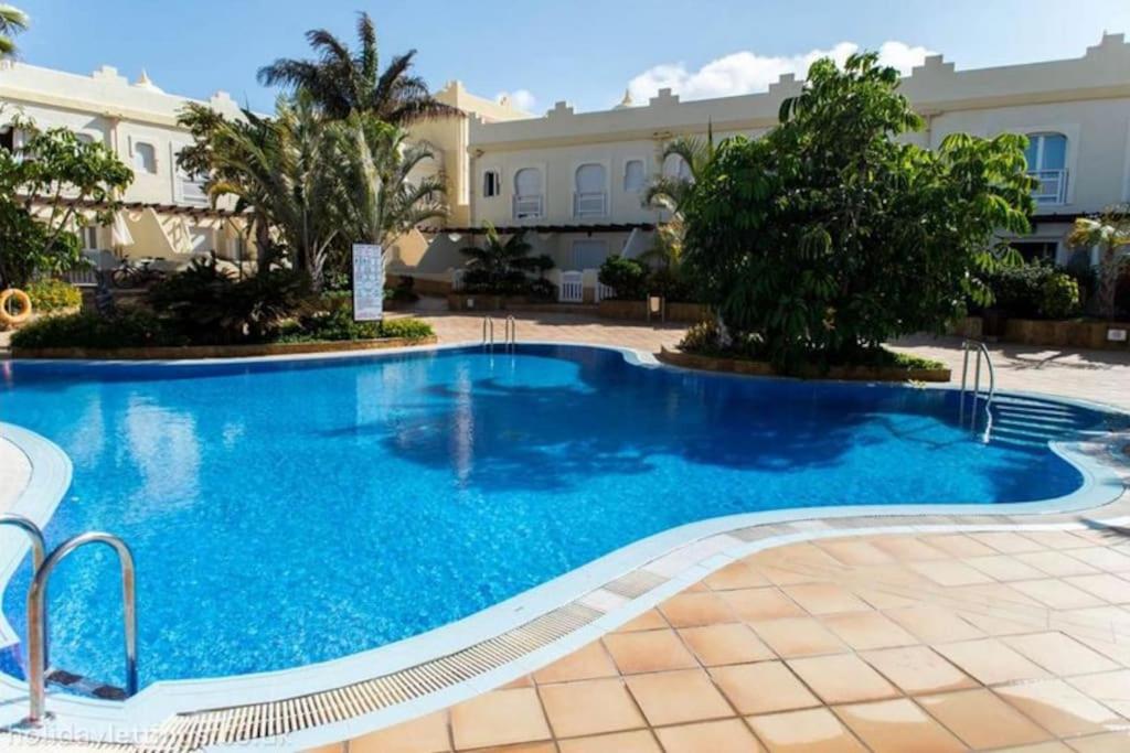 a swimming pool in front of a building at Casa Donn - El Sultán 63 - luxury 3 bed Villa with fast fibre internet in Corralejo