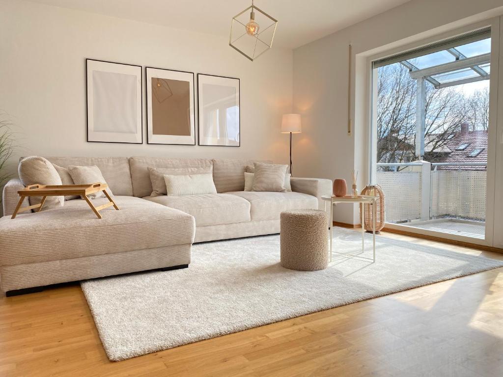 a living room with a couch and a table at RONI APARTMENTS -111qm Luxury Loft -Near Center and Clinics -Netflix -Terrace -Close to Thermal Spa in Bad Aibling