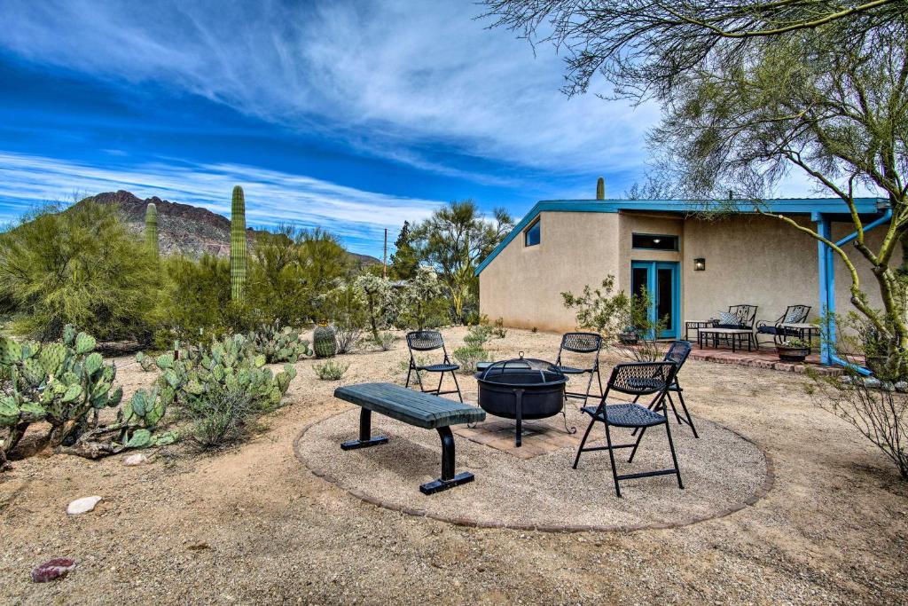 een patio met een grill en stoelen en een huis bij Sunny Tucson Home with Patios on 5 Acres! in Tucson