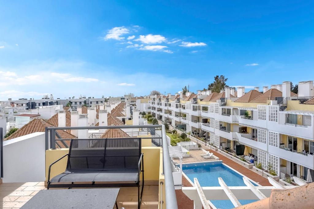 a view from the balcony of a apartment with a swimming pool at Penthouse Papoila in Cabanas de Tavira
