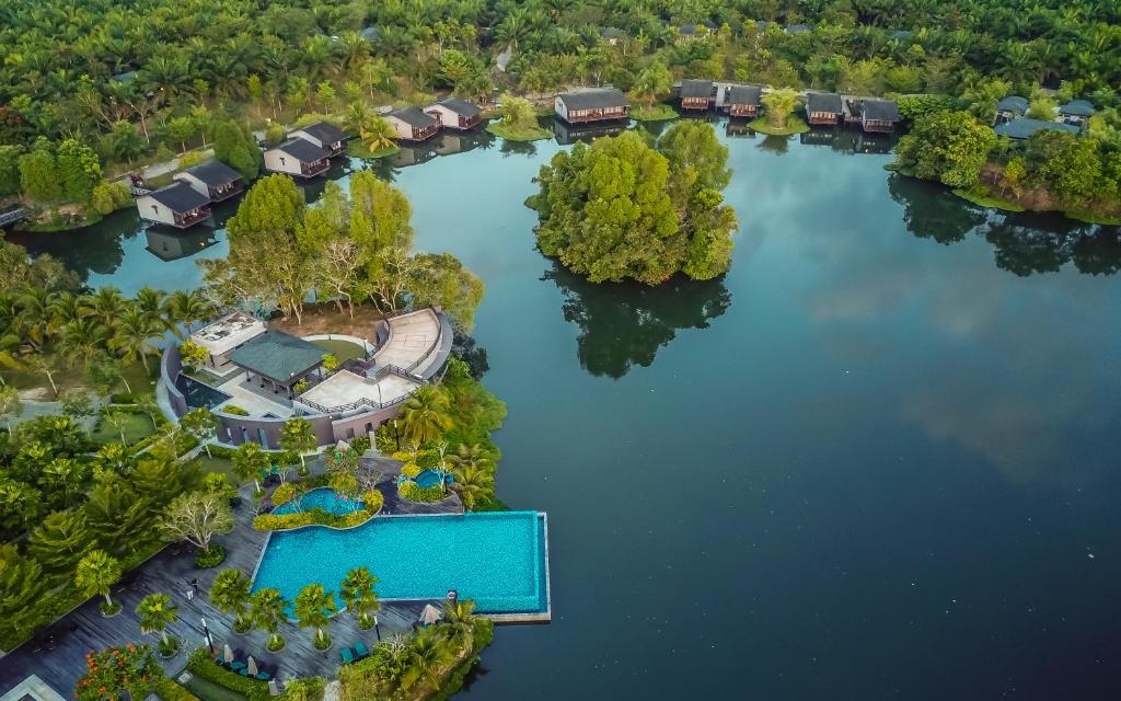 an aerial view of a house on a lake at Mangala Estate Boutique Resort - Small Luxury Hotels of the World in Kuantan