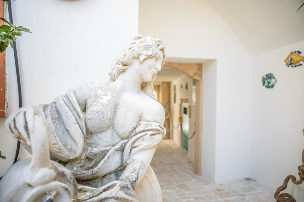 a statue of a woman sitting in a hallway at Casa Celeste in Syracuse