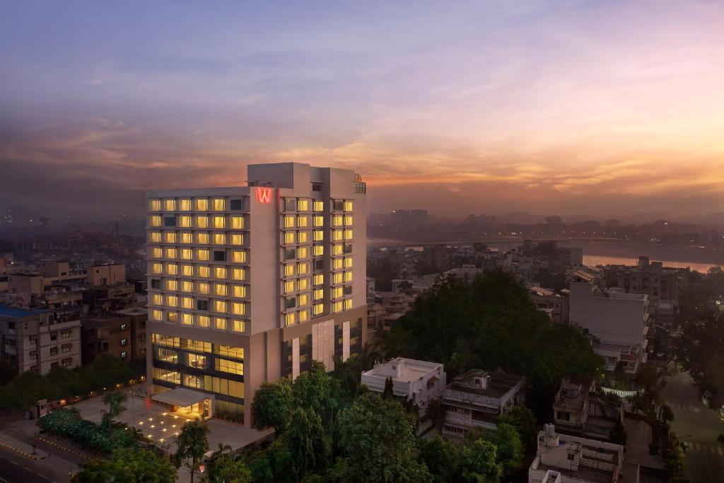 Un edificio alto con luces encendidas en una ciudad. en Welcomhotel by ITC Hotels, Ashram Road, Ahmedabad, en Ahmedabad