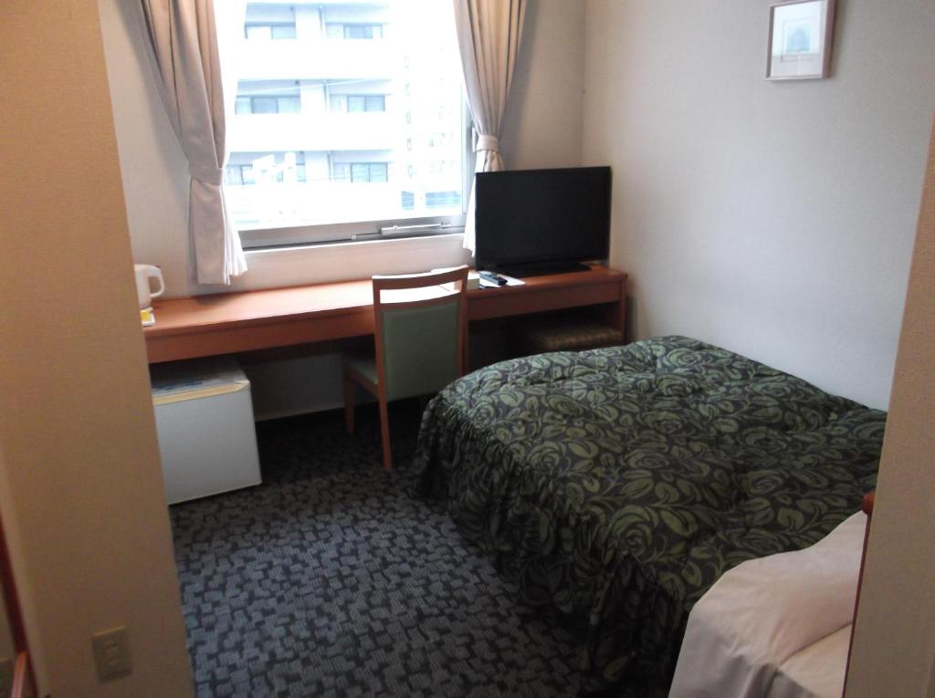 Postel nebo postele na pokoji v ubytování Hotel Sunrise21