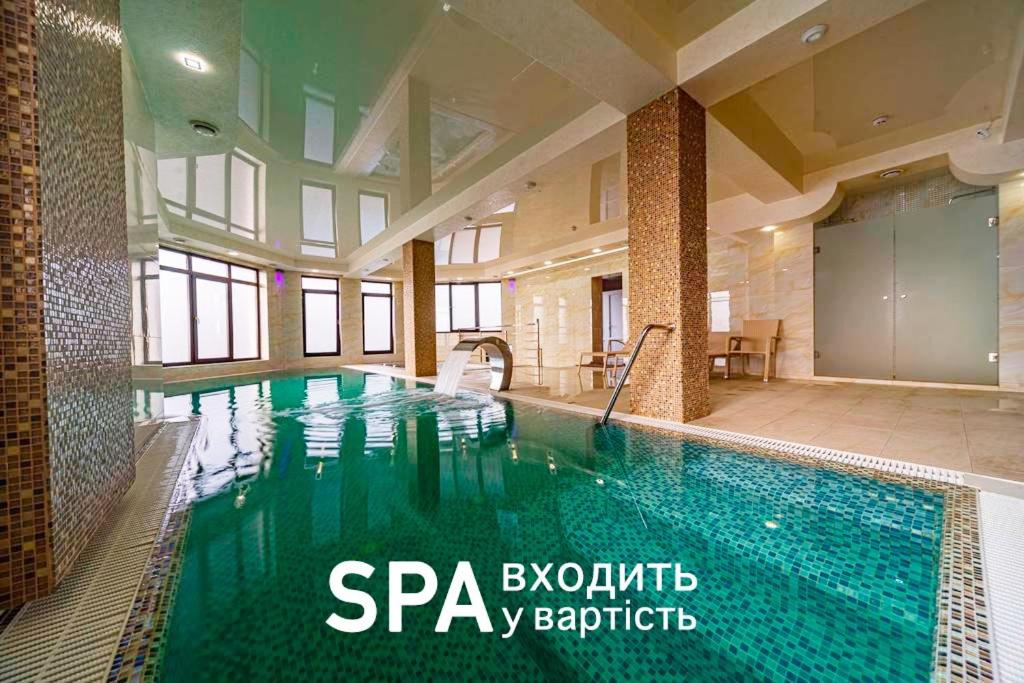 a large swimming pool in a building with a swimming pool at Diamond Resort White in Bukovel