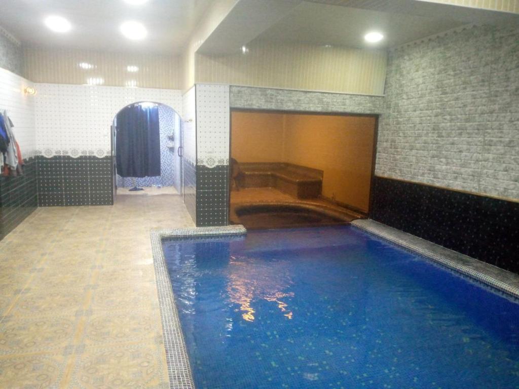 a large indoor swimming pool in a building at Гостевой дом Нилюфар in Kyzyldzhar