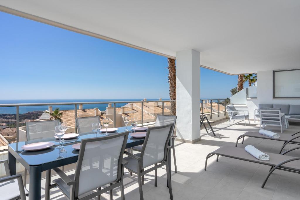 a dining room with a table and chairs on a balcony at Luxurious apartment in Benalmadena Ref 35 in Benalmádena