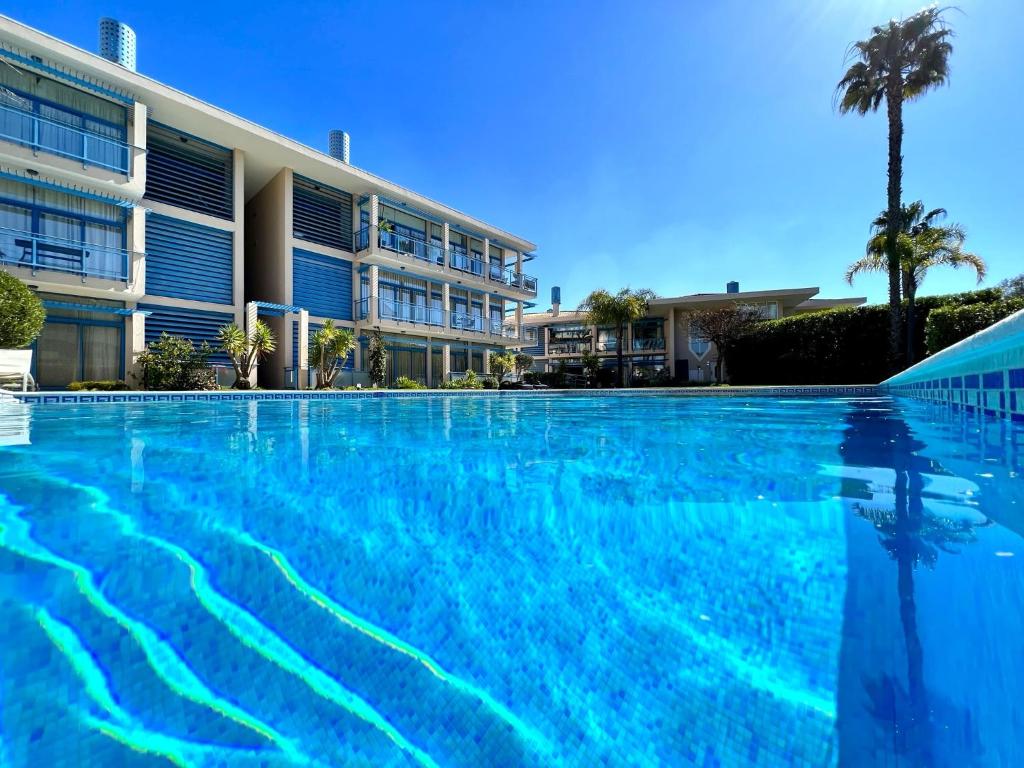 a large swimming pool in front of a building at Vilamoura Prestige With Pool by Homing in Vilamoura