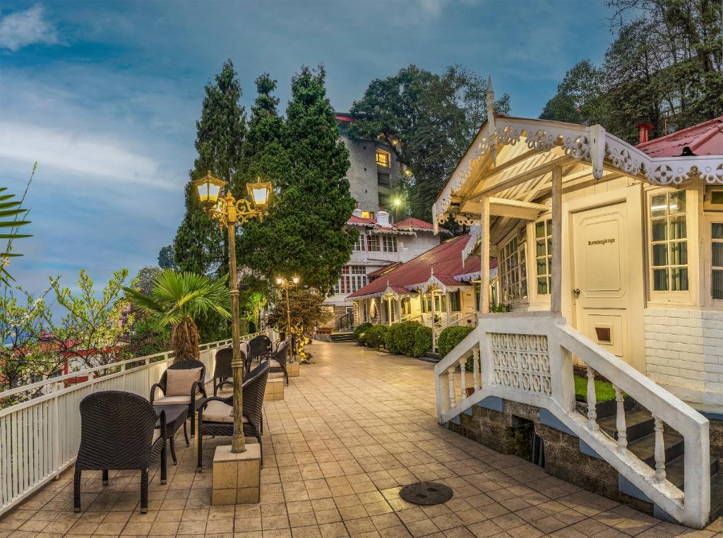 a street with chairs and tables on a sidewalk at Summit Swiss Heritage Resort & Spa in Darjeeling