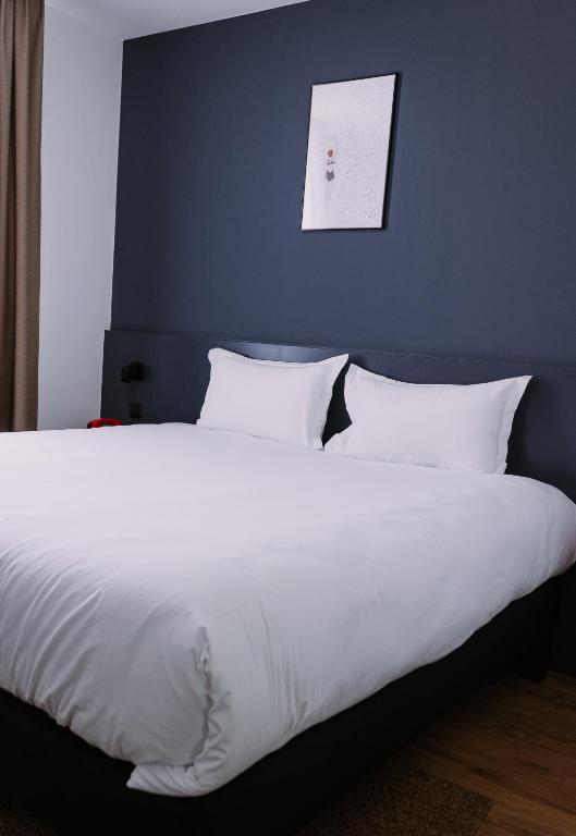 Postel nebo postele na pokoji v ubytování ClapClap Hôtel, Food & Bar