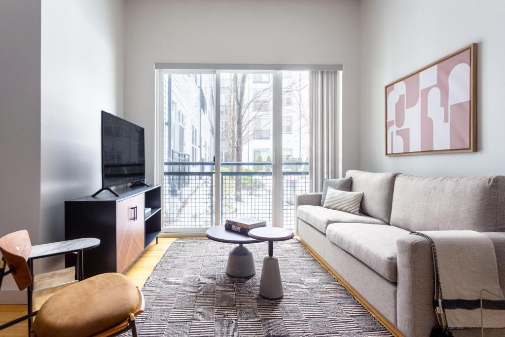 a living room with a couch and a tv at S Boston 1BR w Gym WD by Seaport Lawn on D BOS-335 in Boston