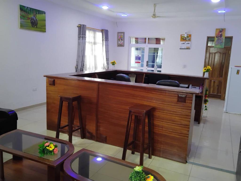 a bar in a living room with two stools at Room in Guest room - Renajoe Exclusive Guesthouse Tema Community 9 in Tema