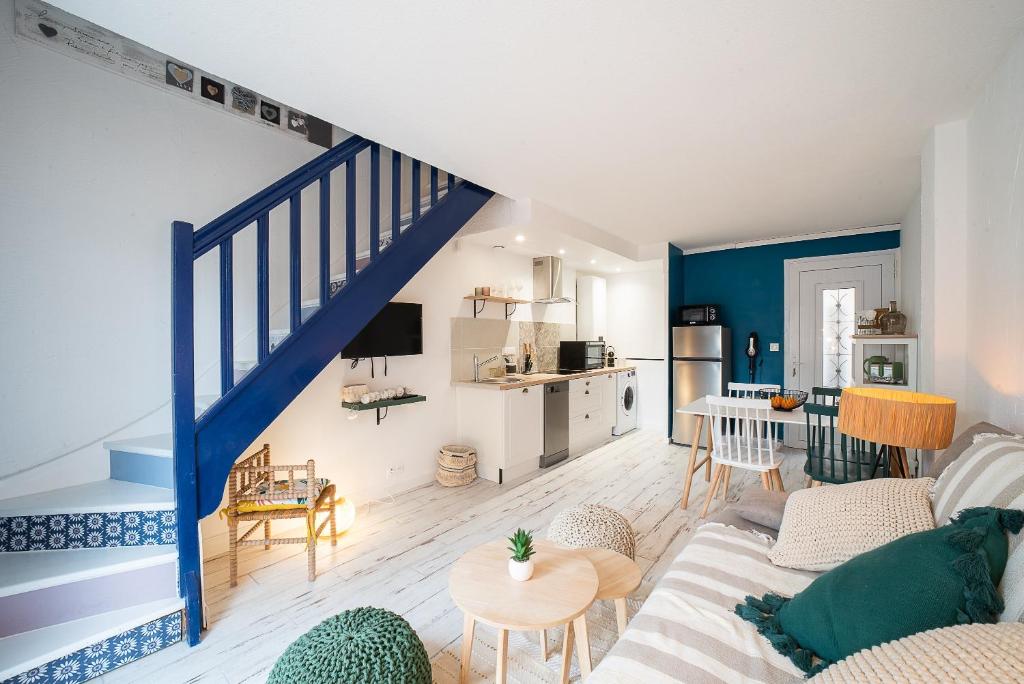 a living room with a blue and white staircase at Perla - Climatisée et proche plage in Canet-en-Roussillon