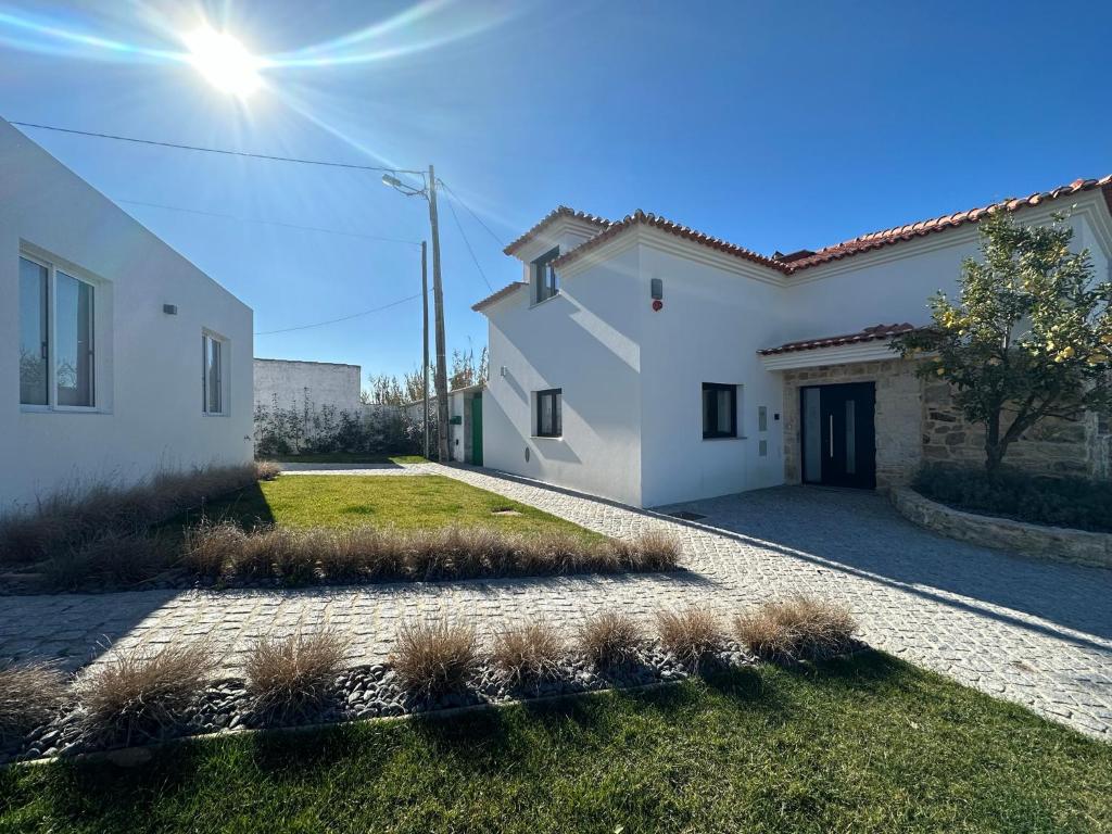 une maison blanche avec allée et pelouse dans l'établissement LUX House 15 min Fatima - Nazare, à Leiria