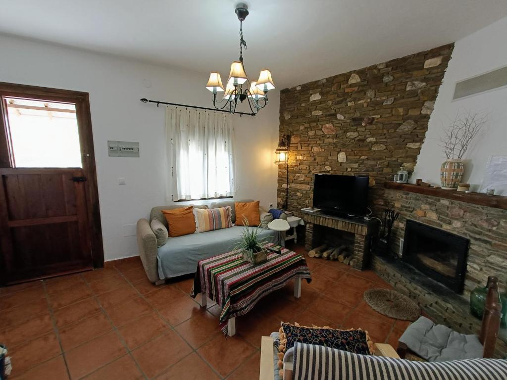 a living room with a couch and a fireplace at Casa Rural El Chacho - Velefique in Velefique