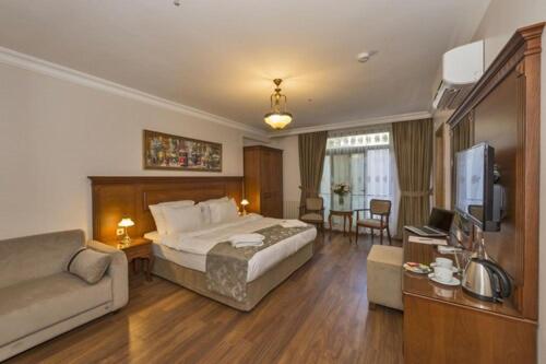 a large hotel room with a bed and a couch at Hotel Blisstanbul in Istanbul