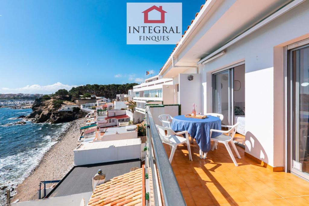 a balcony of a house with a table and chairs at Cala Margarida in Palamós