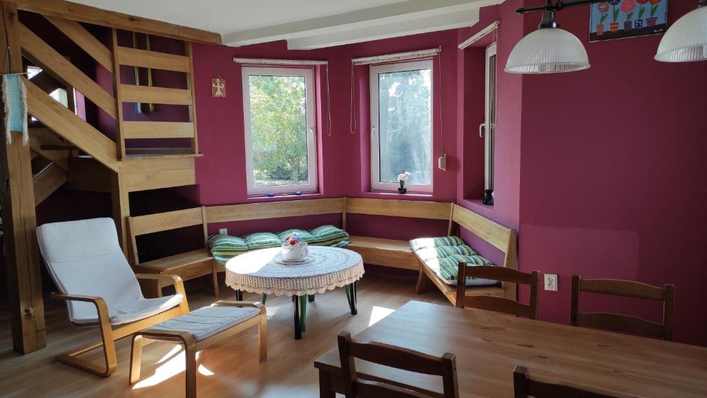 a living room with a table and chairs and a staircase at Siedlisko Gródek Dwór 