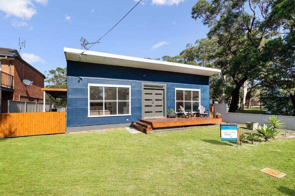 a blue tiny house in a yard at Abode Callala Beach Jervis Bay - 100m to Beach! in Callala Beach