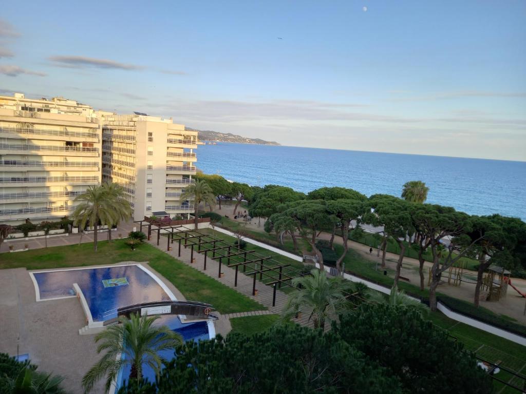 a view of a resort with a swimming pool and the ocean at Appart Cosy T3 (Vue Mer et Piscine 4-5 pers) in Blanes